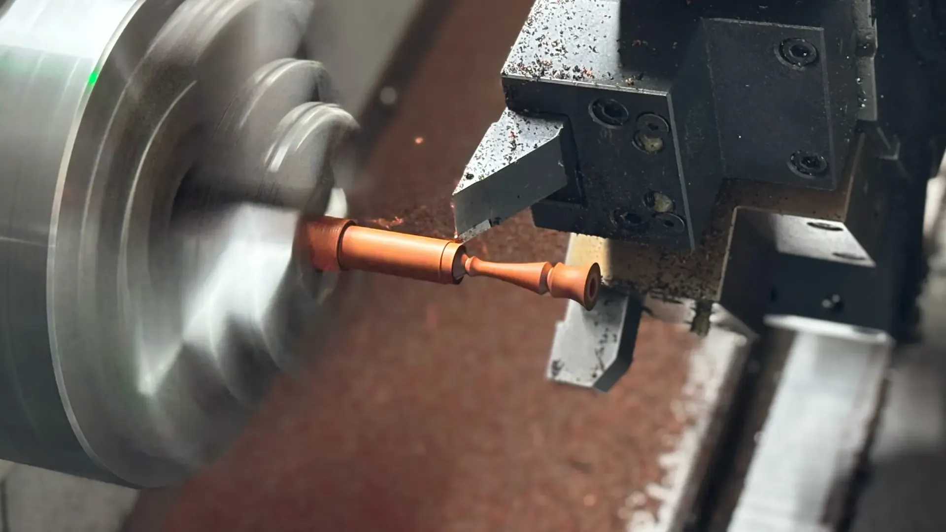 Metal stem being shaped on a CNC lathe