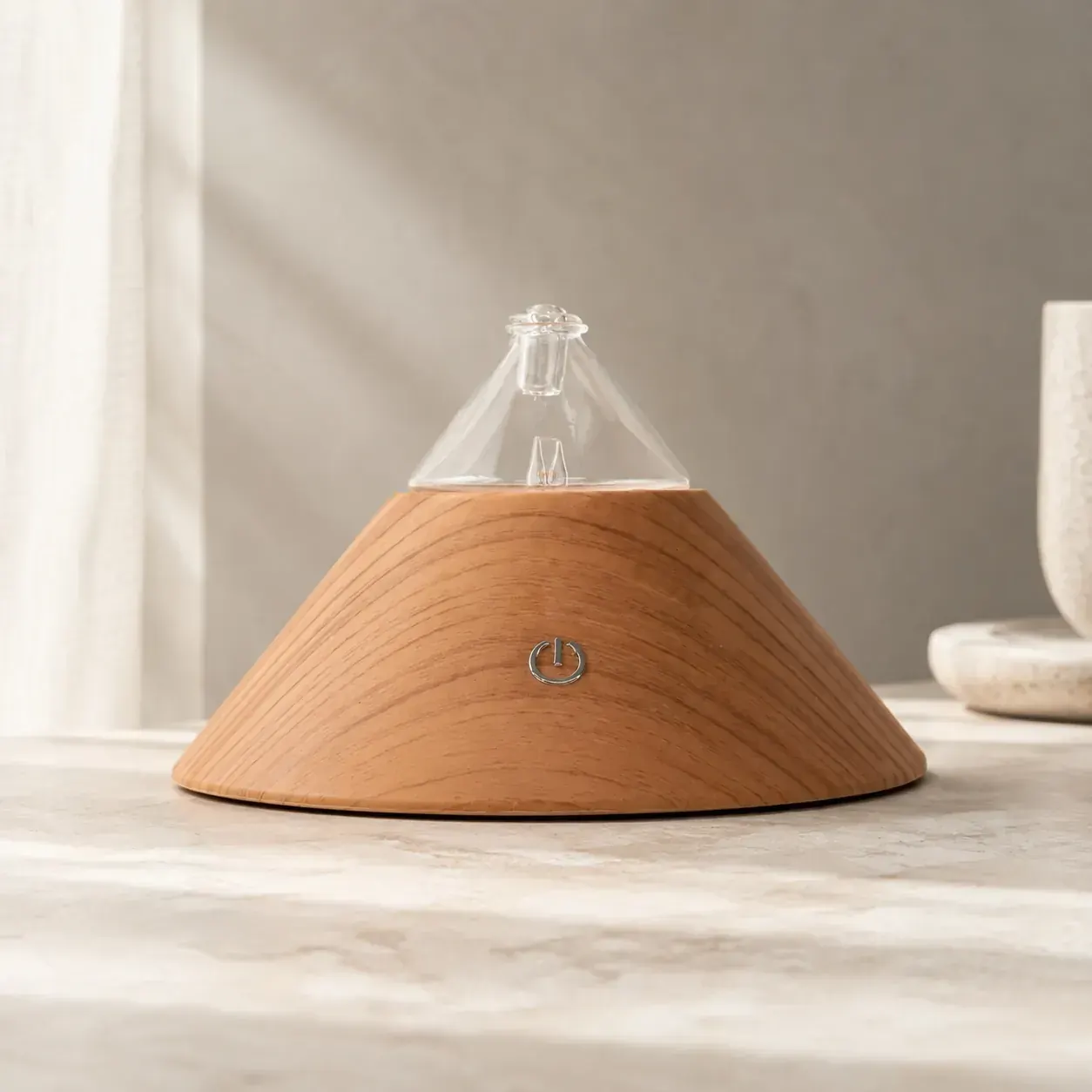 Conical wood-and-glass dual-fluid aroma diffuser on a stone surface