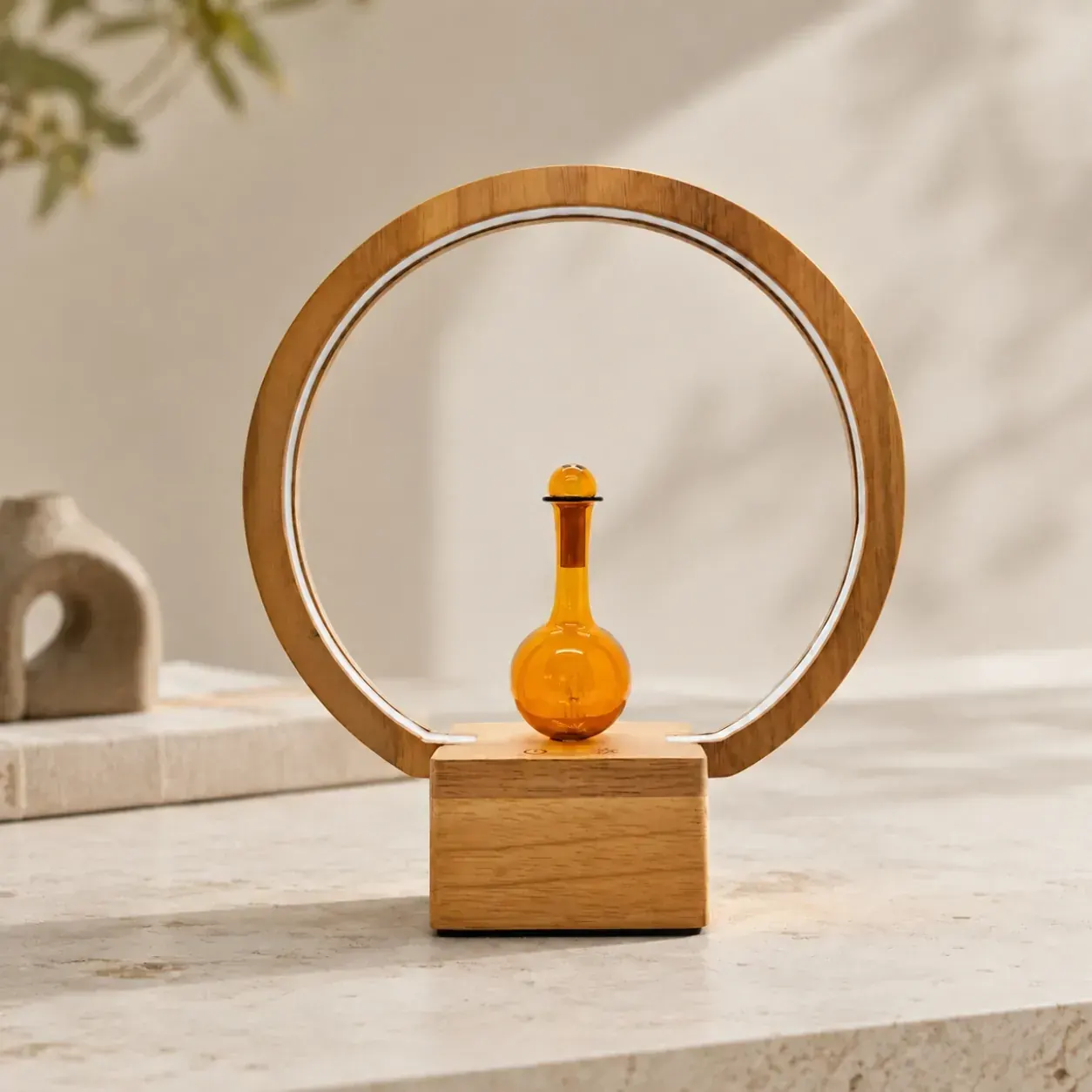 Circular wood-frame dual-fluid aroma diffuser with amber glass flask and rim lighting