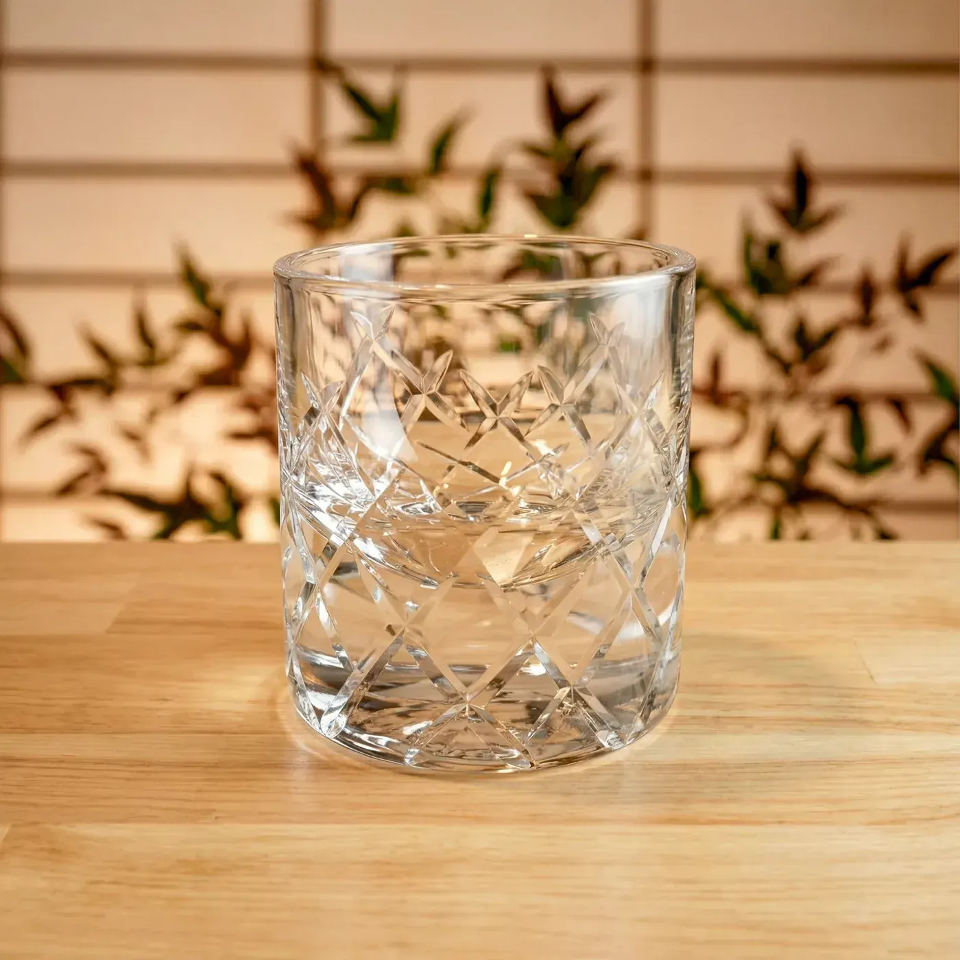 Clear Edo Kiriko rocks glass with basket-weave cut pattern on a wooden table