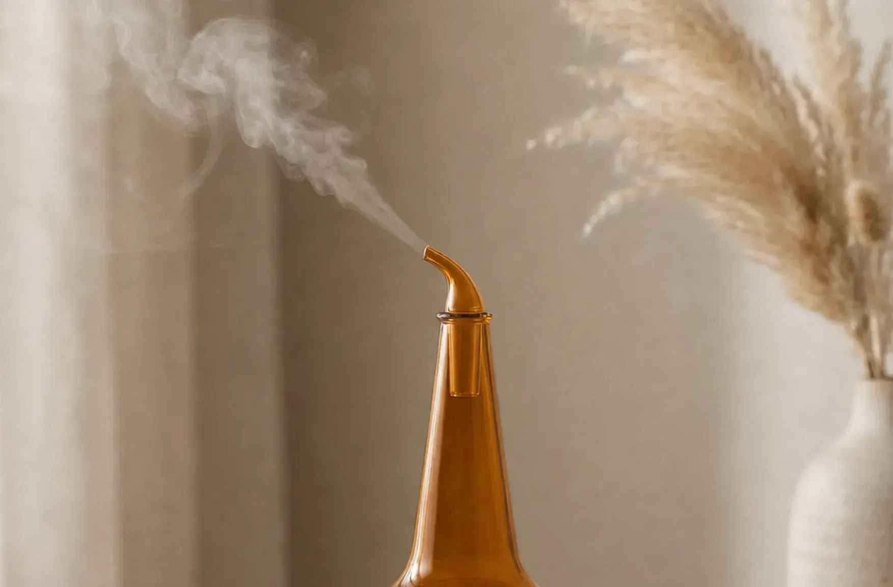 Whiskey nosing diffuser releasing cold two-fluid aroma mist from a clear borosilicate glass reservoir